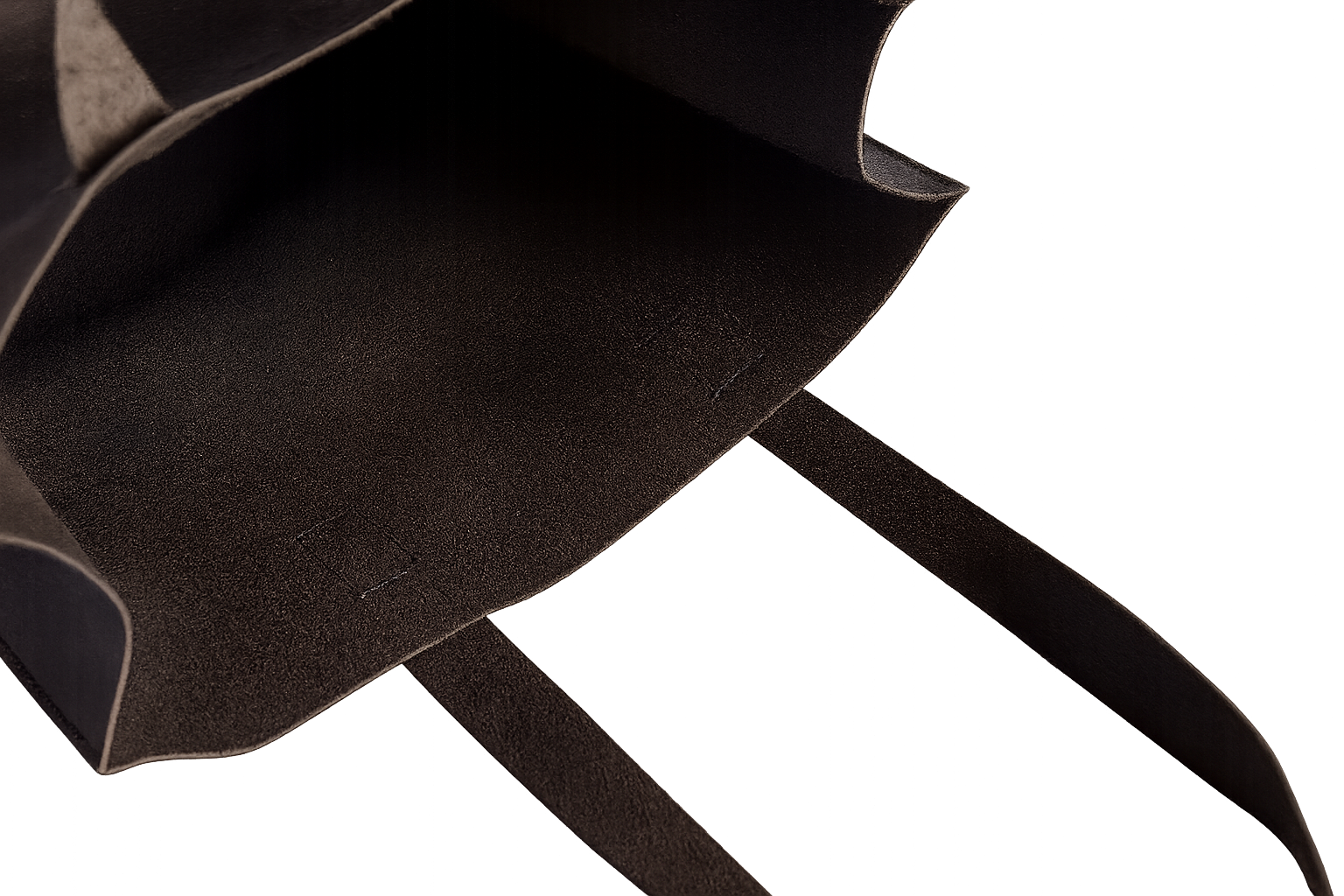 Close-up of a black leather tote with a white background