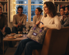 Woman holding a zebra-patterned tote with a brand logo in a cozy indoor setting with friends.
