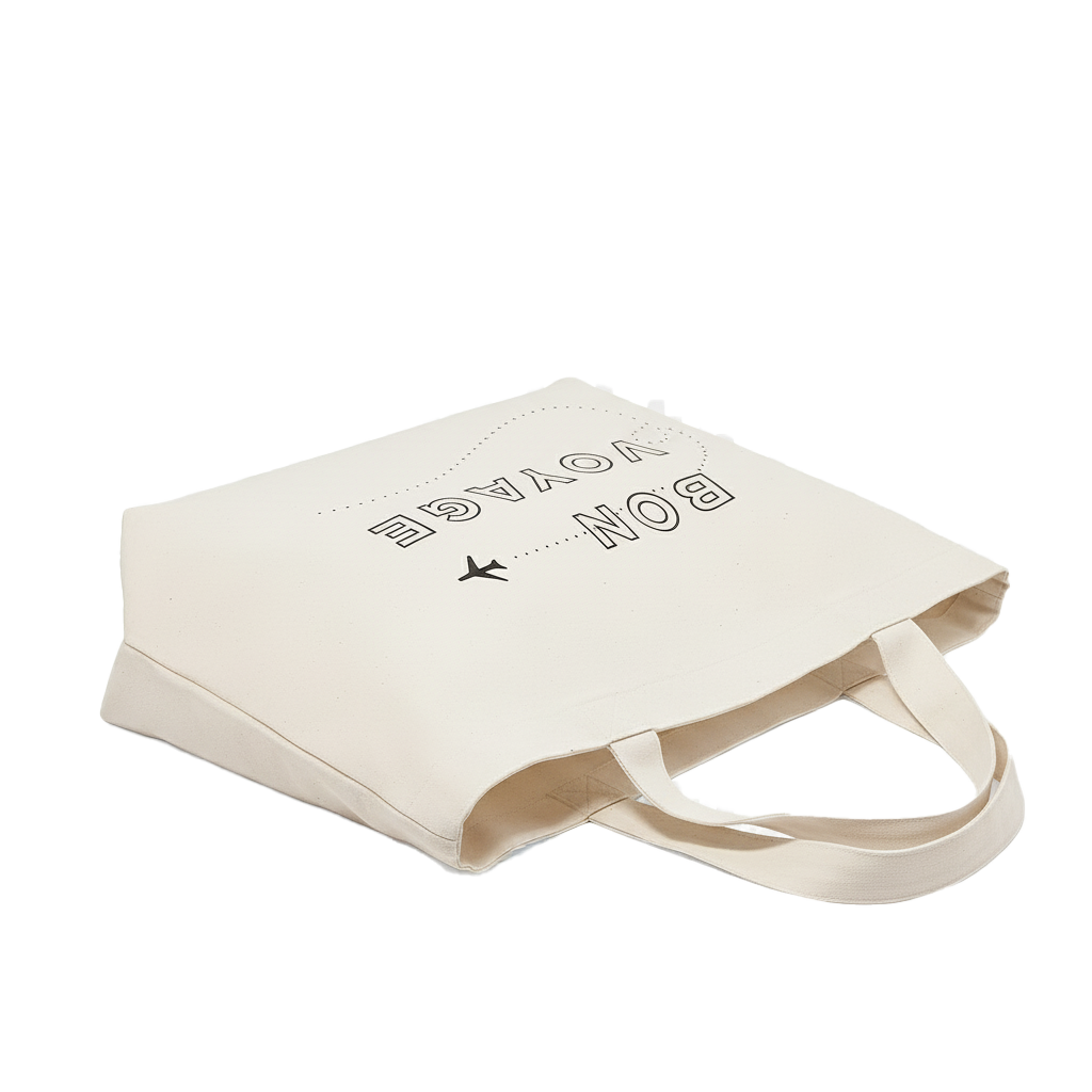 Beige tote bag with text and airplane icon  and text written on it, on a white background