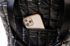 Phone case with camera details in a black quilted bag pocket
