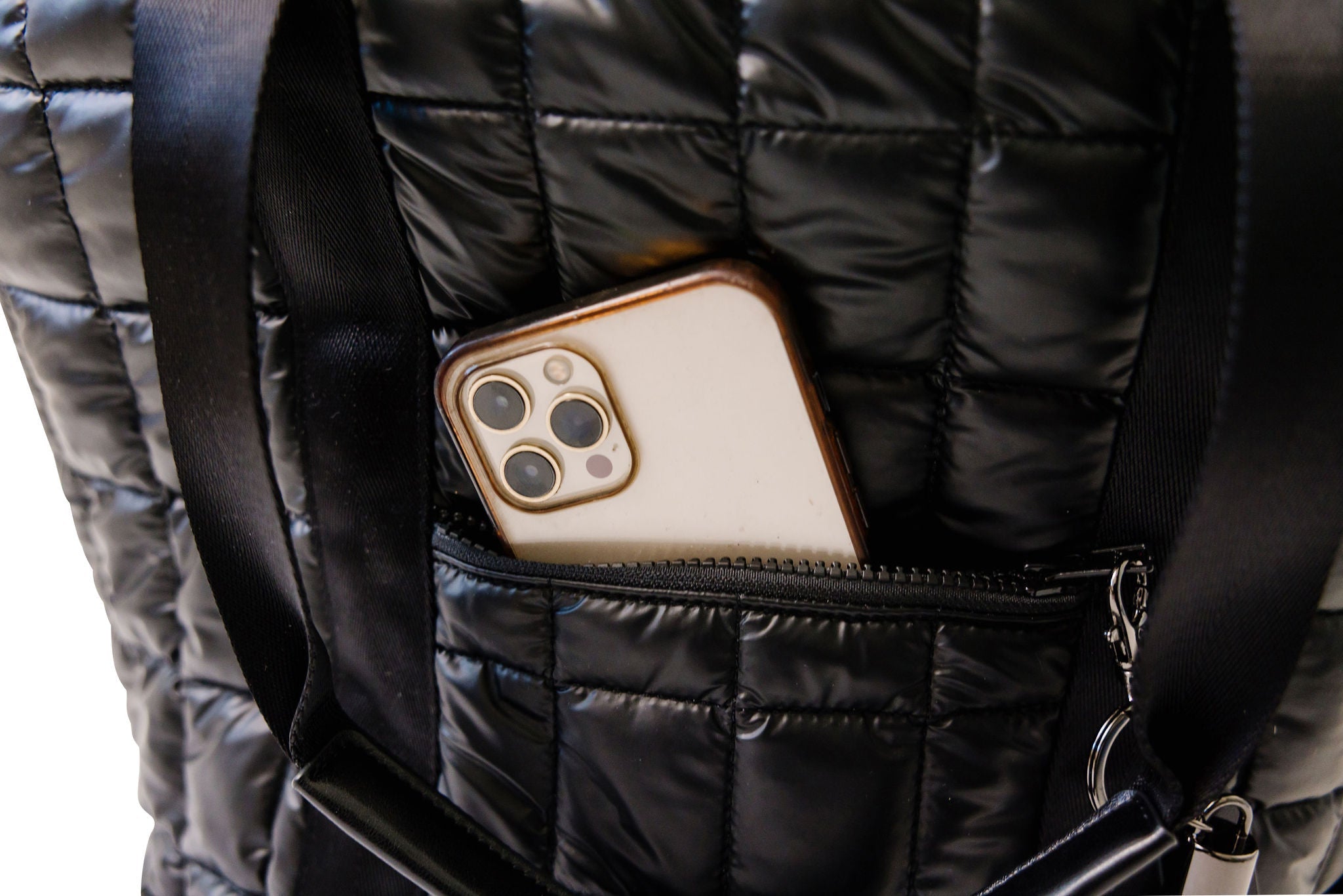 Phone case with camera details in a black quilted bag pocket