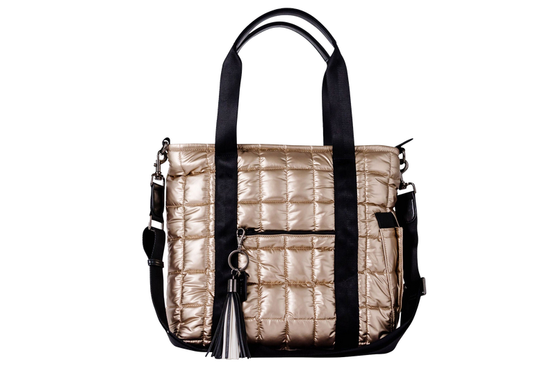 Gold puffer laptop tote with black straps and a black and white tassel