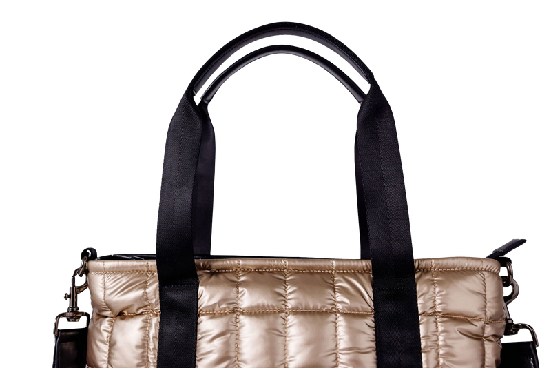 Gold puffer laptop tote with black handles on a white background