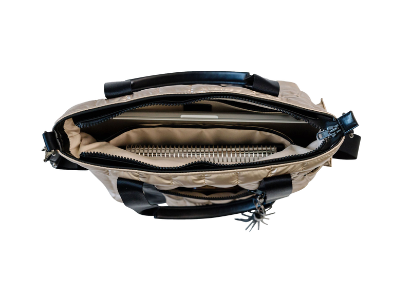 Gold and black puffer laptop tote with zippers on a white background