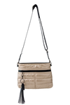 gold handbag with black accents and a tassel on a white background