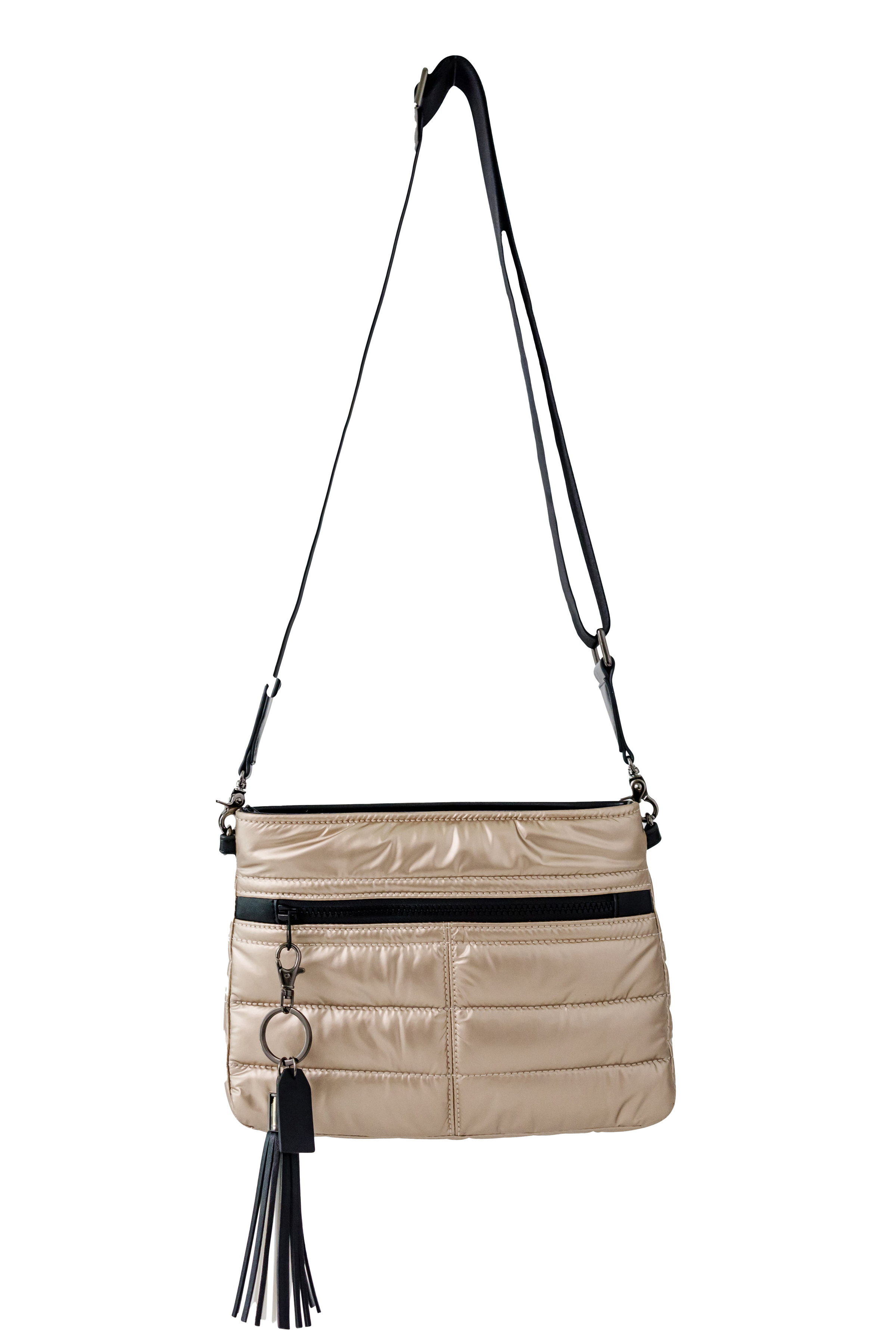 gold handbag with black accents and a tassel on a white background