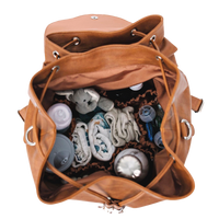 Brown vegan leather tote, open with baby items including bottles and blankets on a white background