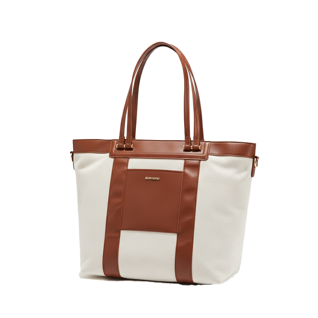 White convertible diaper tote bag with brown leather straps on a white background