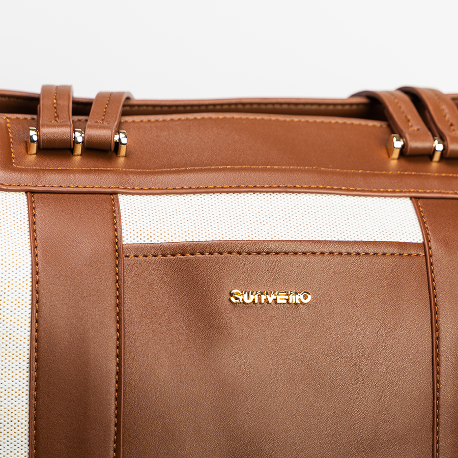 Brown convertible diaper bag tote with gold accents on a white background