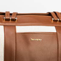 Brown convertible diaper bag tote with gold accents on a white background