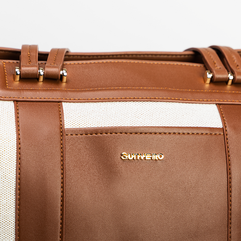 Brown convertible diaper bag tote with gold accents on a white background