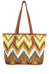 Woven patterned tote bag with zigzag pattern and brown handles on a white background