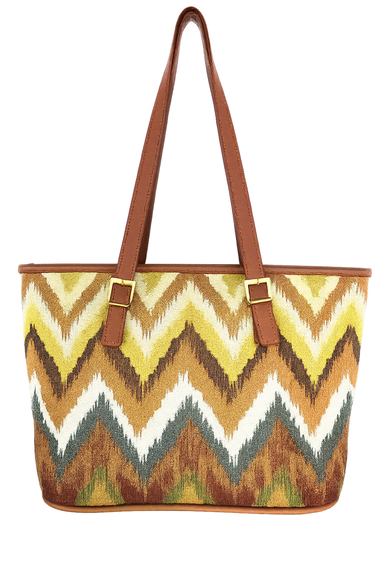 Woven patterned tote bag with zigzag pattern and brown handles on a white background