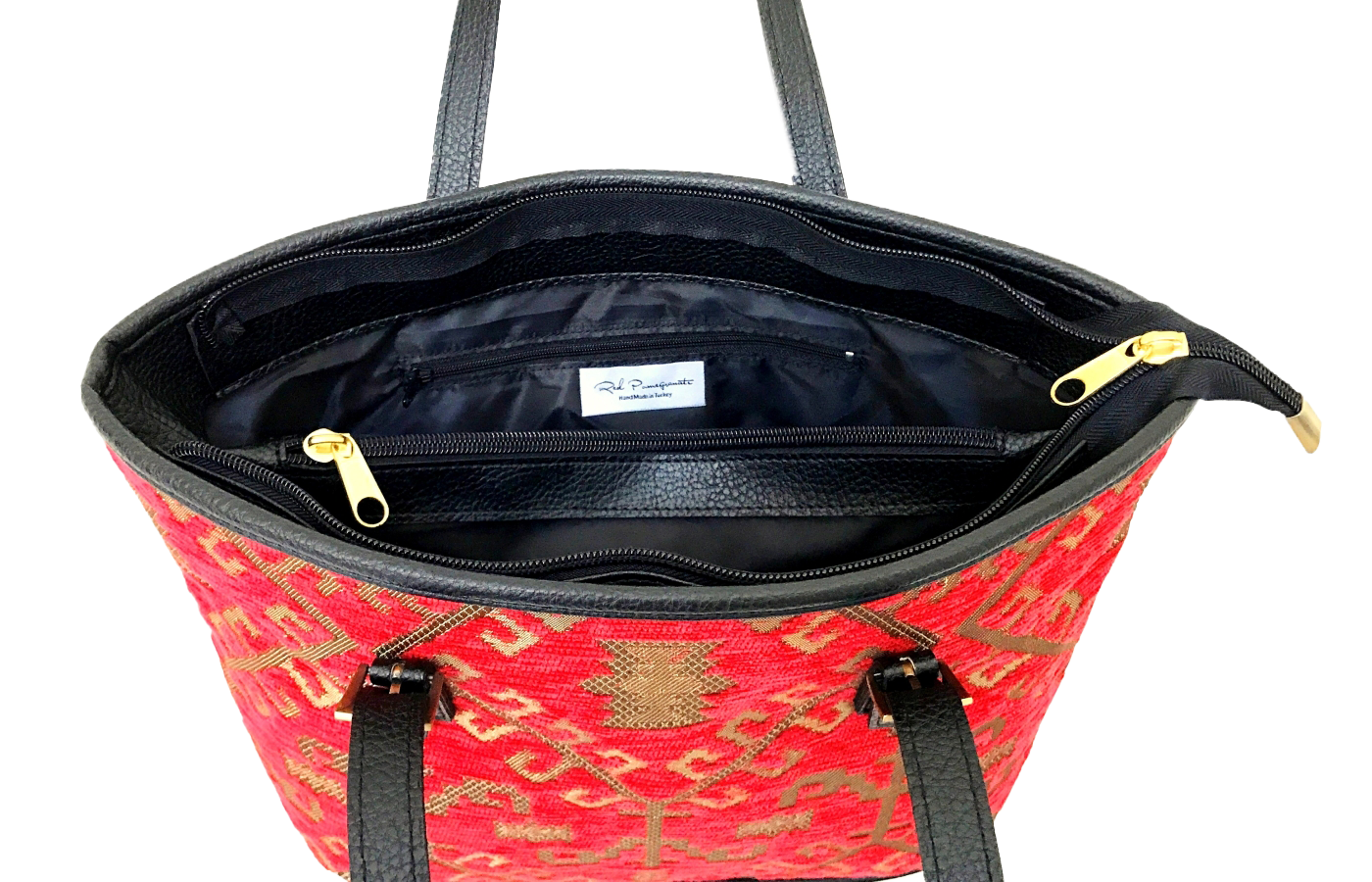 Red patterned woven tote with black interior and gold zipper on a white background