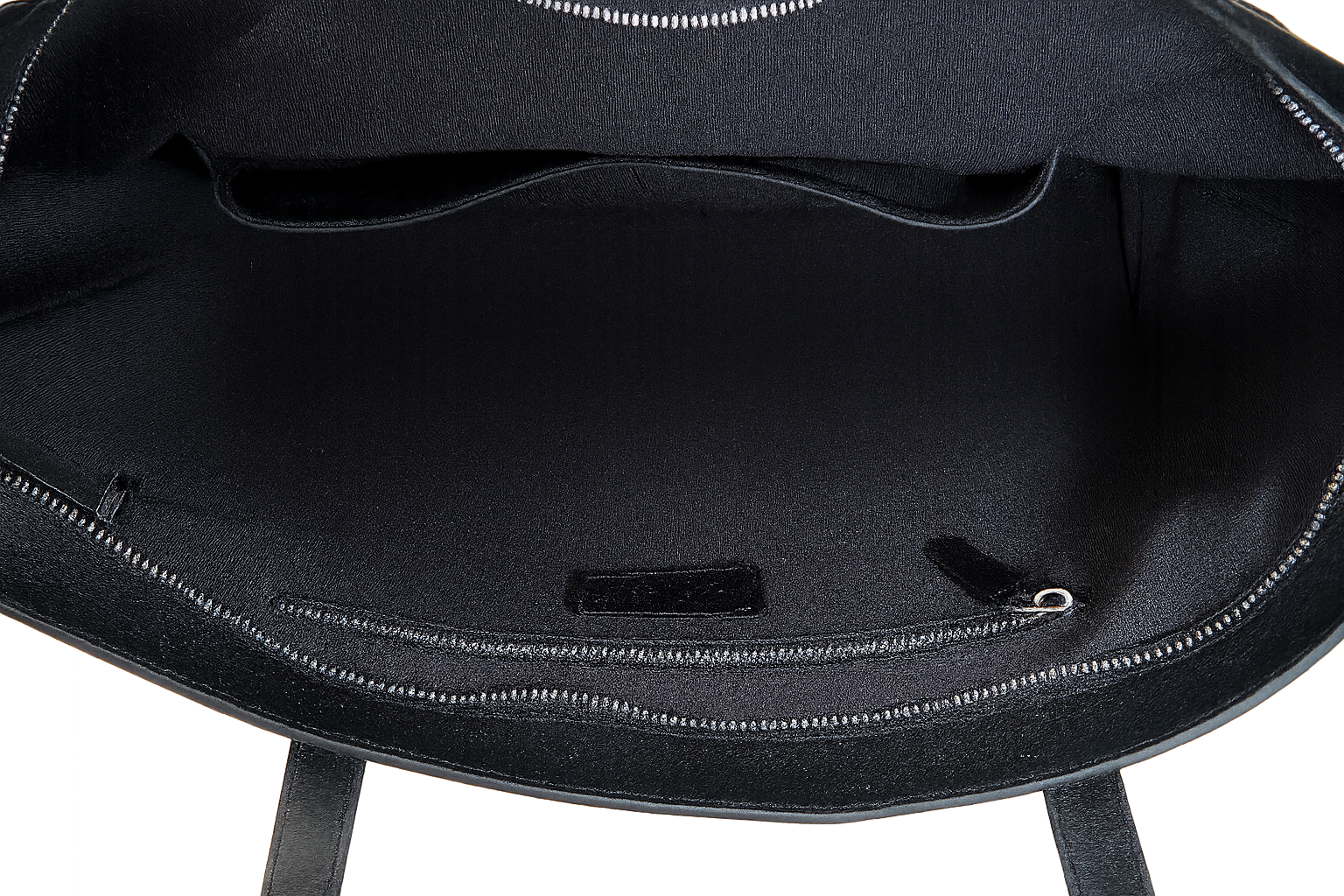 Close-up of a black backpack with visible zippers on a white background