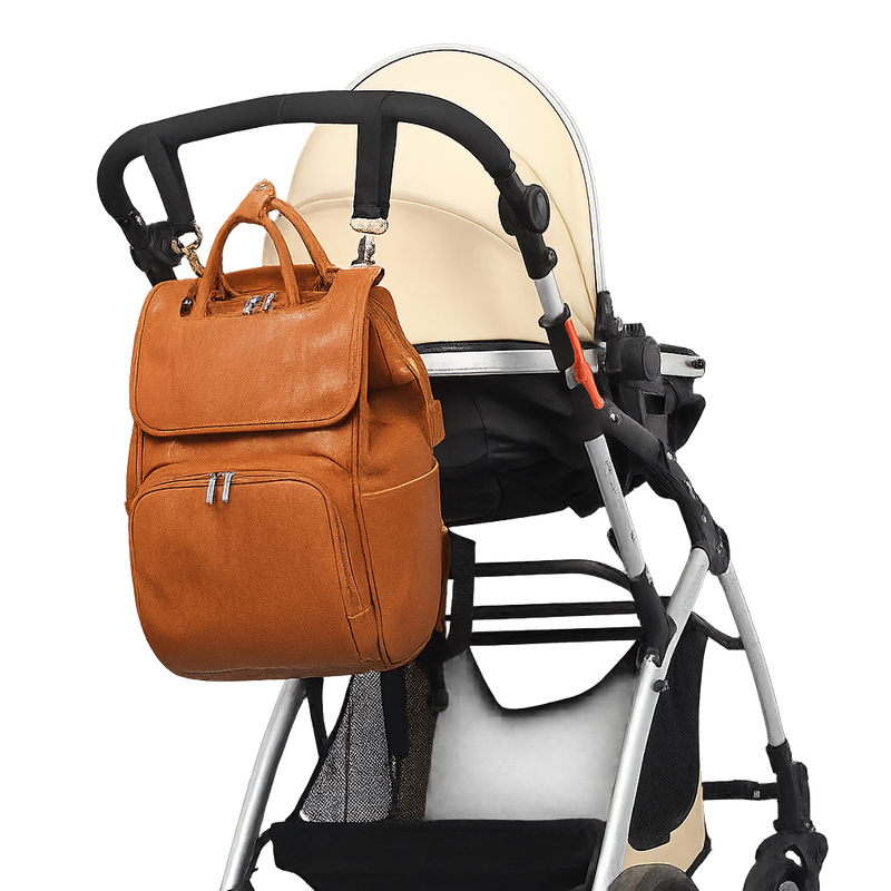 Brown leather backpack attached to a baby stroller on a white background