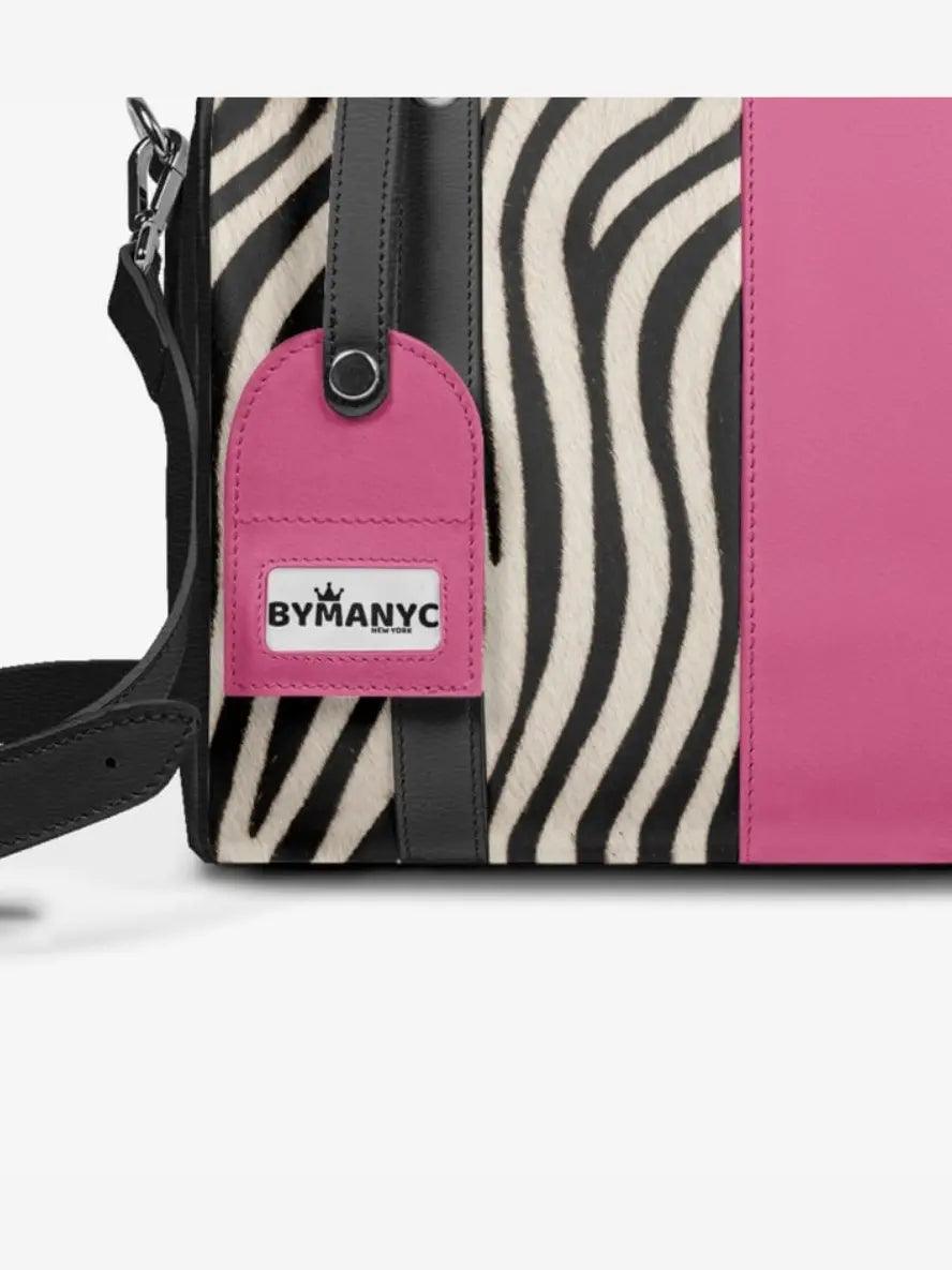 Tote with zebra pattern and pink accent, featuring a BYMANYC tag.