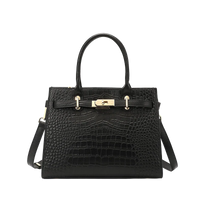 Black crocodile-patterned tote with gold hardware on a white background