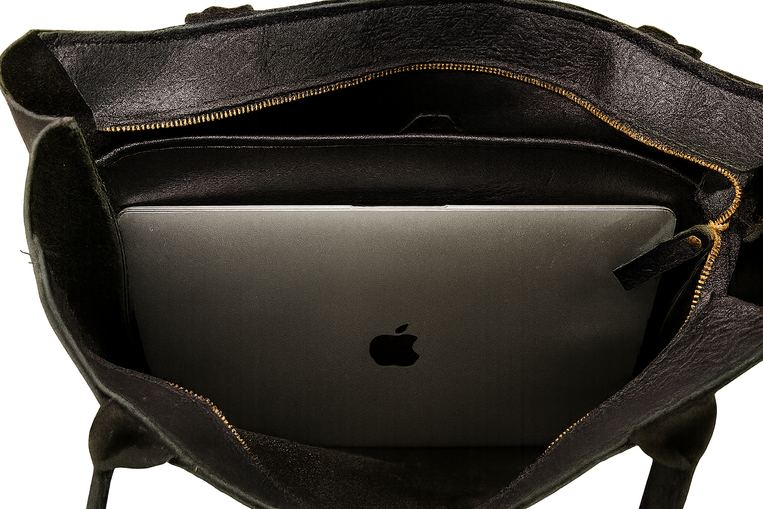 Black leather tote bag with a laptop inside, featuring the Apple logo.