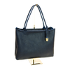 Navy handbag on a gold stand against a white background