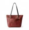 Merlot leather tote bag with black straps on a white background