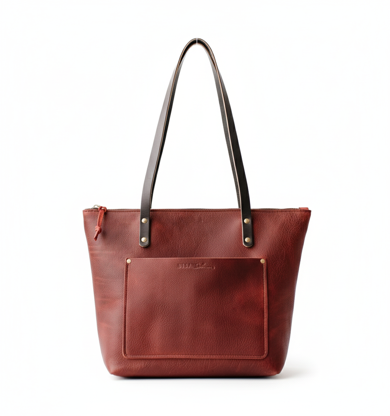 Merlot leather tote bag with black straps on a white background
