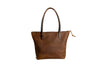 Brown leather tote bag from behind, on a white background