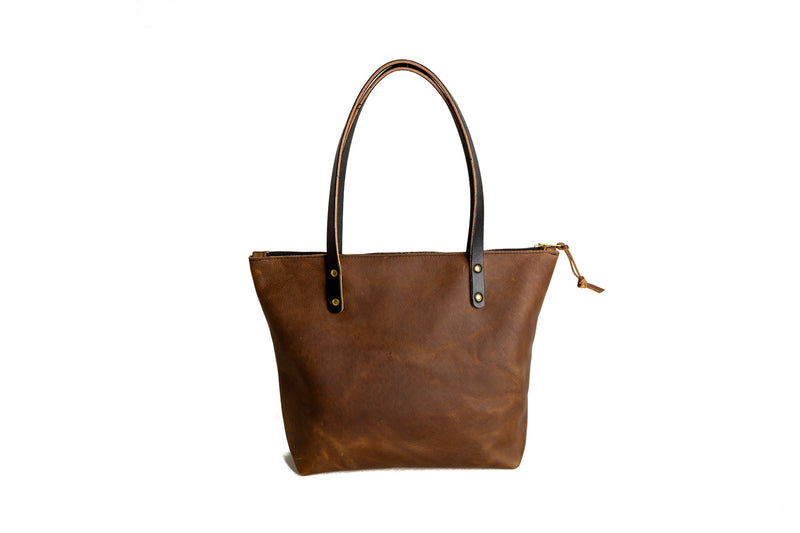 Brown leather tote bag from behind, on a white background