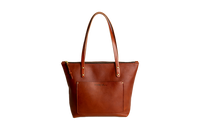 Cognac leather tote bag on a white background