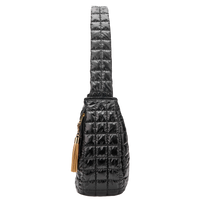 Black quilted crossbody bag with a gold tassel on a white background