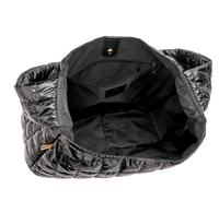Black quilted bag with a white background